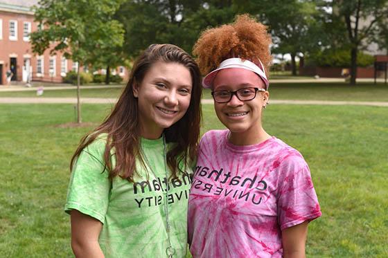 Photo of two women in Chatham University shirts smiling together